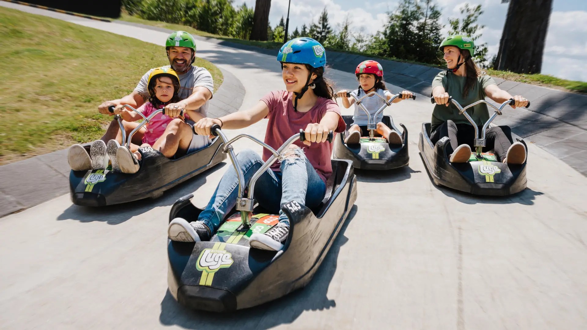 A family rides the Skyline Rotorua Luge together.